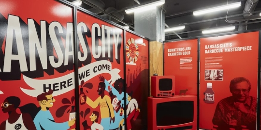 Museum Display signage with Kansas City Here we come, people celebrating, a box television